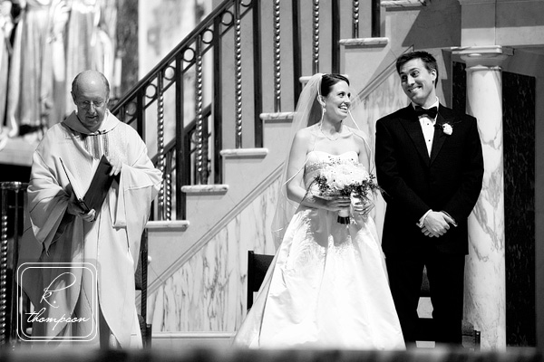 Bride and groom laugh during wedding ceremony at St Matthews Cathedral in Washington DC
