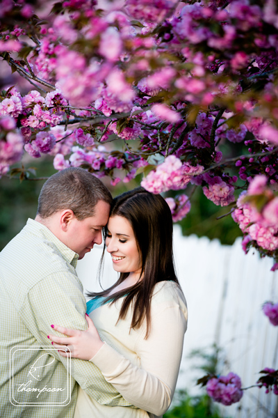 Engaged couple near pink flowers at engagement session in Clifton VA